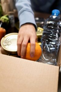 A person holding an orange Source: Photo by cottonbro studio: https://www.pexels.com/photo/food-wood-man-people-6590924/